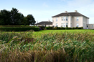 Irish resort home with grassy landscape